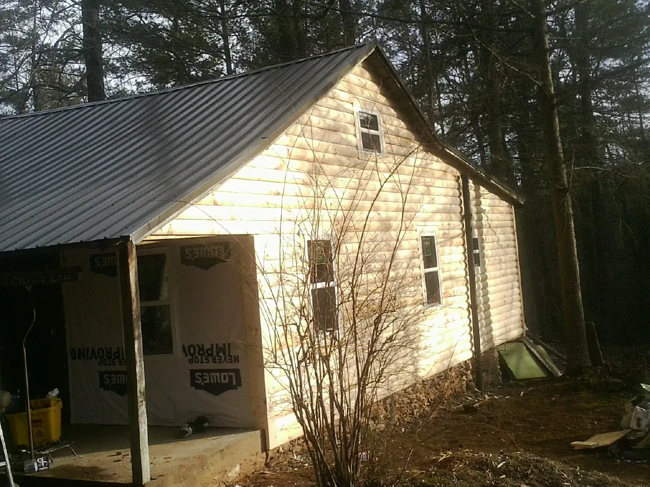 Log siding gable end under a dark metal roof edge in York