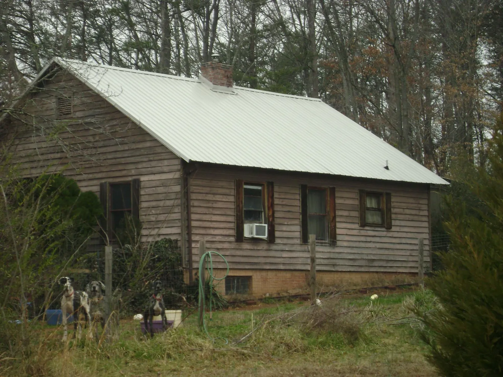 White metal roof on an old wood sided farmhouse, from a Metal Roof Installation job in York